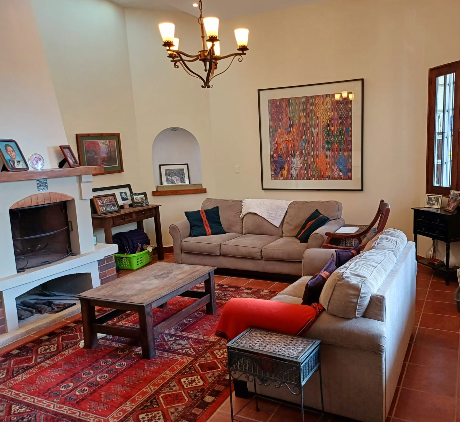 Warm, cozy living room with fireplace and Guatemalan textile art
